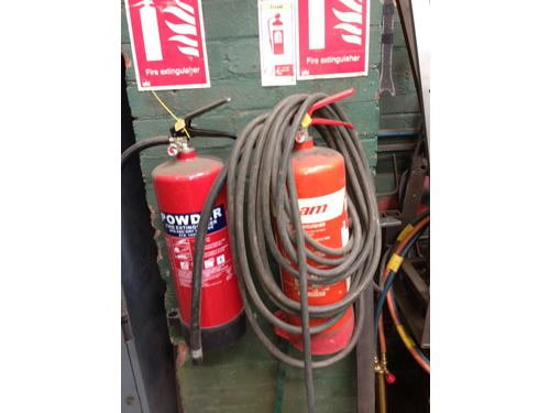 Fire extinguisher blocked by hose