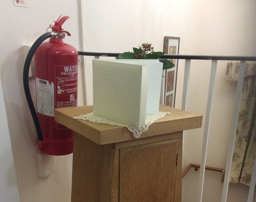 Guest book pulpit blocks fire extinguisher